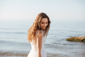 Canvas Print - Young beautiful woman in wedding dress on beach