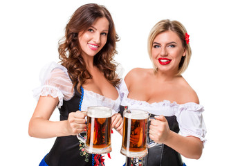 Two beautiful blond and brunette girls of oktoberfest beer stein