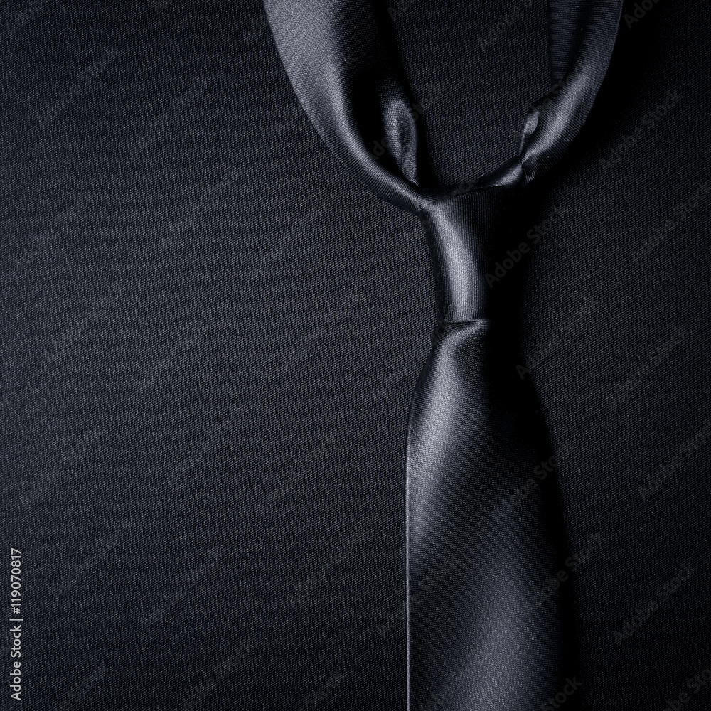 black tie on a black background - obrazy, fototapety, plakaty 