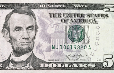 Portrait of the US President Abraham Lincoln on five dollar banknote bill, front side obverse.