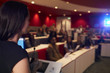 © Monkey Business - Woman lecturing students in lecture theatre, focus foreground