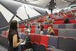 © Monkey Business - Woman lecturing students in a university lecture theatre