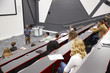 © Monkey Business - Man lectures students in lecture theatre, mid row seat POV