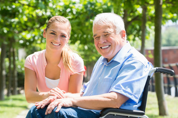 Smiling Young Woman With Her Disabled Father