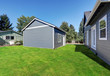 Blue siding house with matching detached garage