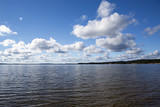 Fototapeta Morze - Beautiful summer view. Image taken in Finland on a summer afternoon with blue sky and clouds. Clouds are reflecting from the water.