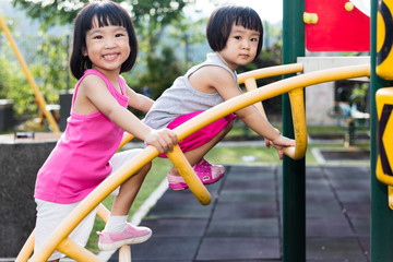 Wall Mural - Asian Chinese little girl climbing at playground