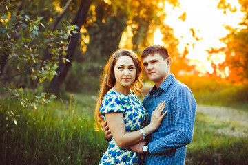 Loving couple embracing sitting in the woods.