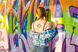 Fototapeta  - Girl on a background of graffiti
