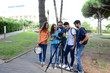 group of young photography students with teacher during outdoor photo course