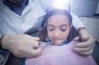 © WavebreakMediaMicro - Dentist examining a young patient with tools