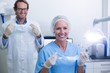 © WavebreakMediaMicro - Portrait of dentist and dental assistant wearing surgical mask