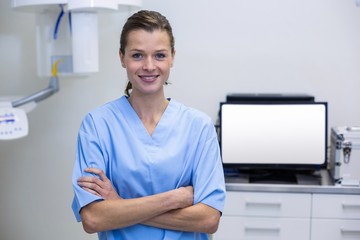 Portrait of dental assistant standing with arms crossed