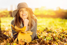 Happy Young Woman In Park On Sunny Autumn Day