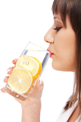 Wall Mural - Woman drinking water with lemon