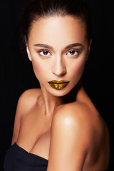 Wall Mural - Beautiful model with bronze skin and gold lipstick. perfect skin texture. 