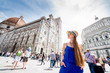 Leinwanddruck Bild - Young female traveler standing on Cathedral square in front of Santa Maria del Fiore church in Florence. Having great vacations in Italy