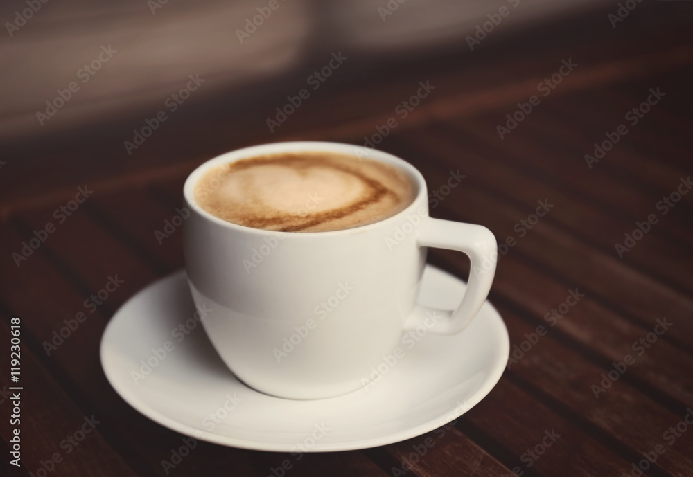 Cup of fresh coffee on wooden table