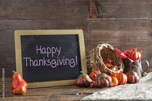 Happy Thanksgiving Written In Purple Chalk On Black Chalkboard