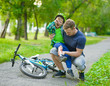 © Ermolaev Alexandr - father inspects the injured child had fallen off the bike