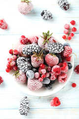 Poster - Frozen berries on a white wooden table