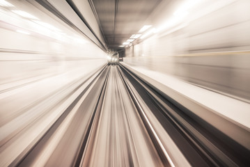 Fast underground train riding in a tunnel of the modern city