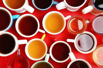 Poster - Cups of tea on red background, top view