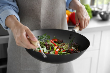 Poster - Female hands holding pan with vegetables closeup