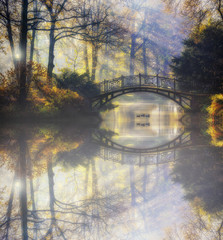 Poster - Beautiful romantic bridge in a park with colorful trees and sunlight and reflections in pond water autumn background
