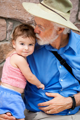 Grandfather Kisses Toddler Granddaughter