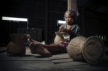 Wall Mural - Asian grandmother fisherman with the net bamboo