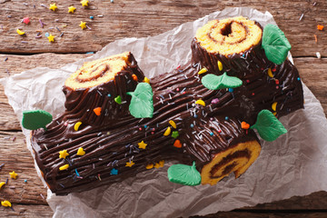 Wall Mural - Traditional chocolate Christmas log roll close-up. Horizontal top view. rustic style
