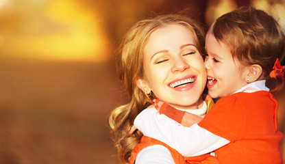 happy family. mother and child little daughter play kissing on a