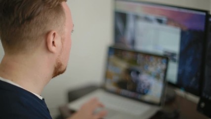 The man the programmer works behind the laptop