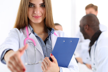 Wall Mural - Female medicine doctor offering hand to shake