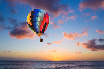 Wall Mural - Hot air balloon over the sea at sunset