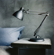 A Lamp On A Bedside Table.