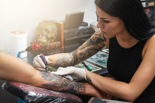 Tattoo Artist During Her Work