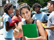 © Daniel Ernst - Laughing caucasian female student showing thumb with group of friends