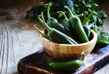 Hot green jalapeno pepper in bowl, selective focus