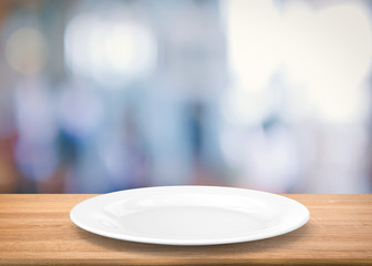 white empty dish on wooden table