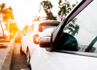 White car on the parking with sunset.