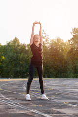 Young cute girl warming up before workout 