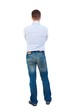 © ghoststone - back view of Business man looks. Bearded businessman standing arms folded.