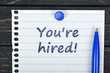 You're hired text on page and pen