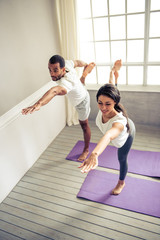 Wall Mural - Afro American couple doing yoga