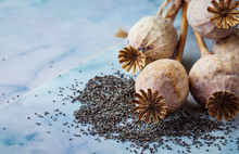Poppy Seeds And Heads On Wooden Background