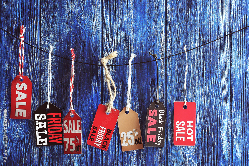 Sale labels hanging on wooden background