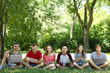© Africa Studio - Young people with gadgets in a park