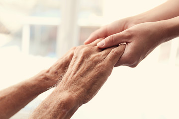 Old male and young female hands, closeup